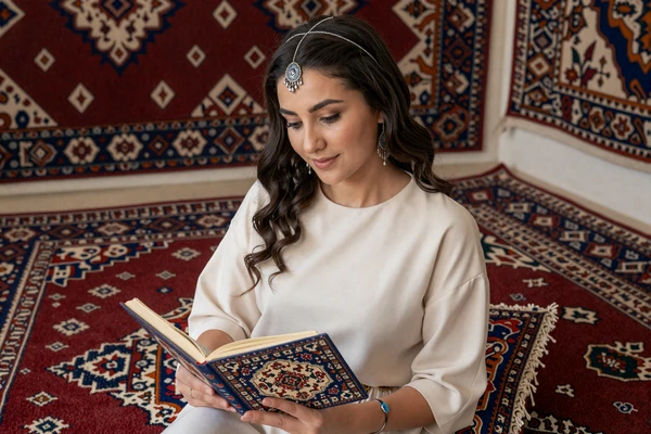 Turkmen woman reading Magtymguly poetry near a handwoven Turkmen carpet with traditional gul patterns, reflecting the literary and carpet-weaving heritage central to Turkmen women dating